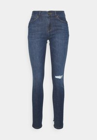 Jeans skinny azul escuro, feitos de denim, com cintura alta, detalhe rasgado no joelho direito e design tradicional de cinco bolsos.