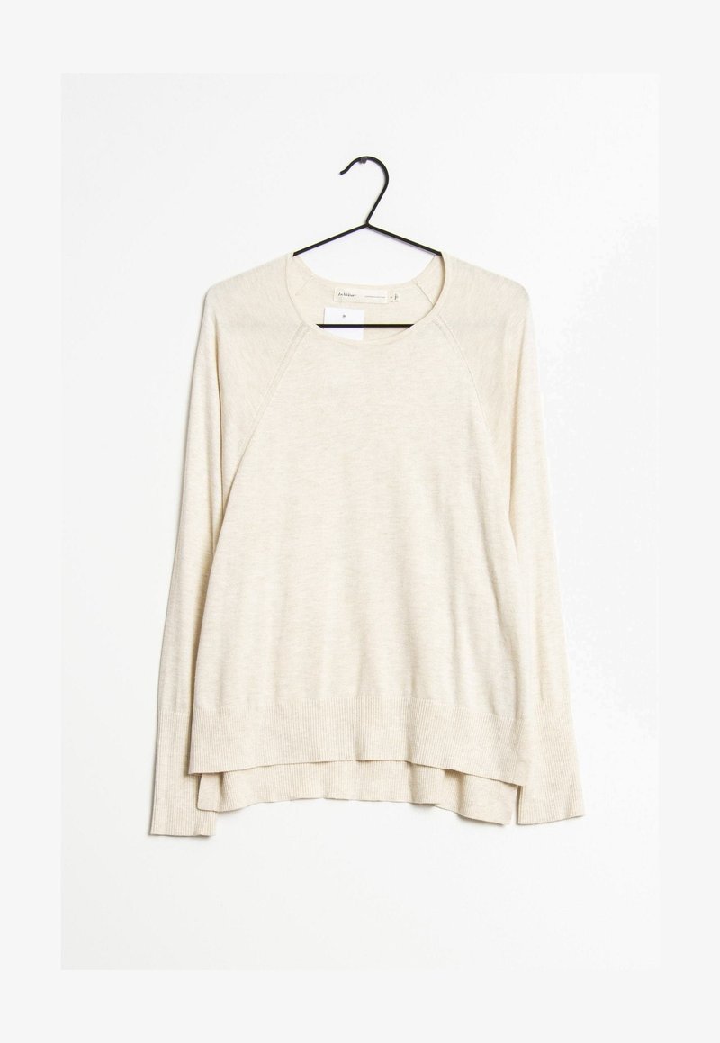 Ljusbeige tröja med rund halsringning, långa raglansärmar och ribbad nederkant. Har en lager-på-lager design baktill för extra detalj.