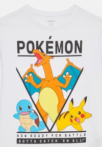 Charizard with wings spread, Squirtle standing, and Pikachu in battle pose on a white shirt with "Pokémon" and battle text.