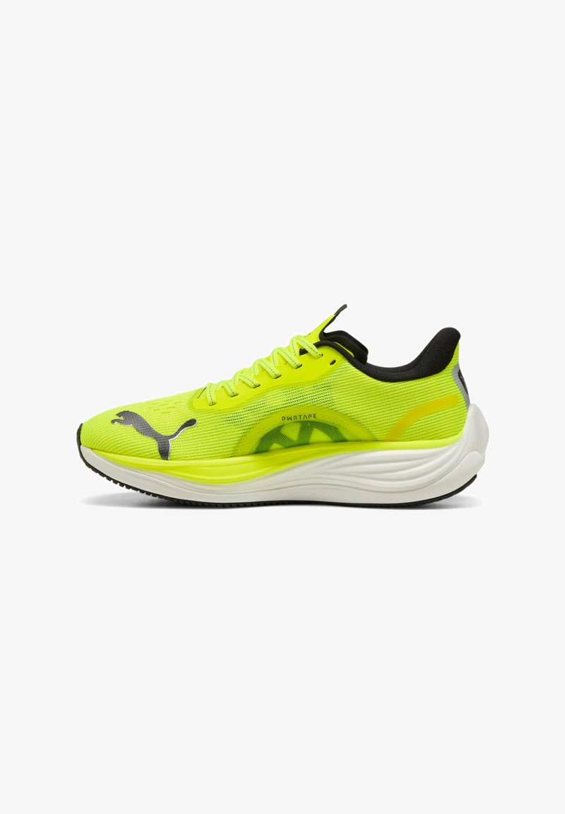 Neon yellow athletic shoe with a textured mesh upper, black accents, and a cushioned white sole. Features a prominent logo on the side.