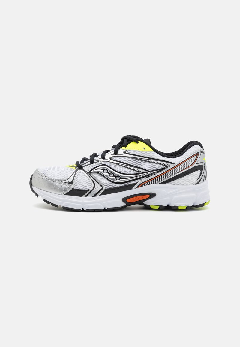 Shoe desportivo branco com parte superior em malha, detalhes em preto e amarelo, sola acolchoada e sola exterior em borracha texturizada com realces laranja.