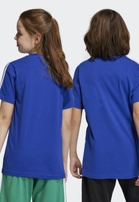 adidas Performance TEE - Camiseta estampada - semi lucid blue/white