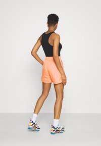 Nike Sportswear Treningo apatinė dalis - atomic orange/black