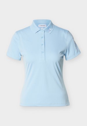 Light blue short-sleeve polo shirt with button placket, small collar logo, and brand name on left sleeve.