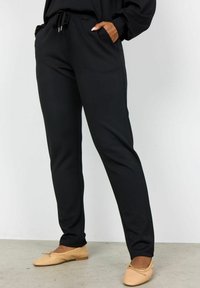 Black sweatpants made of soft fabric, featuring an elastic waistband with a drawstring, side pockets, and a straight leg design.