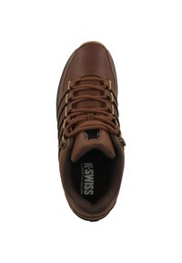 Hnědé kožené tenisky s texturovaným svrškem, bronzovými očky a hnědými tkaničkami. Mají polstrovaný límec a značku na stélce.