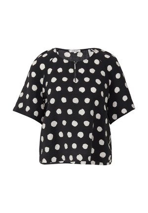 Black short-sleeve top with white polka dots, round neckline, and a subtle front zip detail. Made from a lightweight, textured fabric.