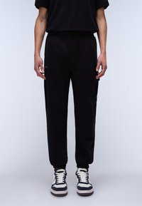 Napapijri - BADGE - Tracksuit bottoms - black Thumbnail Image 1