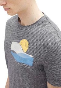 Gray striped t-shirt with short sleeves, featuring a multicolored graphic of a sun and waves on the front. Round neckline, cotton fabric.