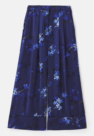Navy blue skirt with a floral print featuring blue and white flowers. Fabric is smooth with pleats and a wide hem.