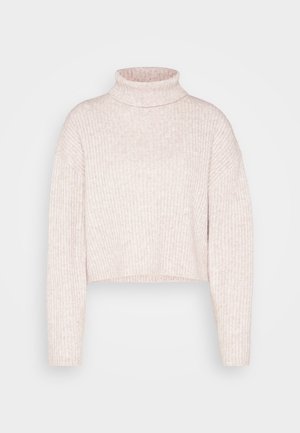 Pull à col roulé côtelé rose clair, longueur cropped, avec des manches longues et une texture douce. Design minimaliste sans quincaillerie visible.