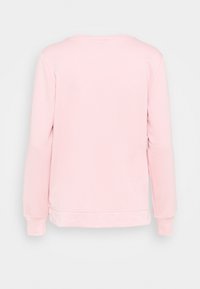 Ljust rosa långärmad sweatshirt sedd bakifrån, med ribbade ärmslut och rak nederkant.