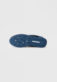 Talpa de pantof sport din cauciuc albastru cu un model texturat pentru aderență, având o bandă albă de accent și un design turnat pentru tracțiune.