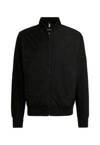 Musta pommijakki, jossa on pystykaulus, vetoketjukiinnitys, joustavat hihansuut ja helma, sekä teksturoitu materiaali. Jakki on valmistettu kevyestä kankaasta.