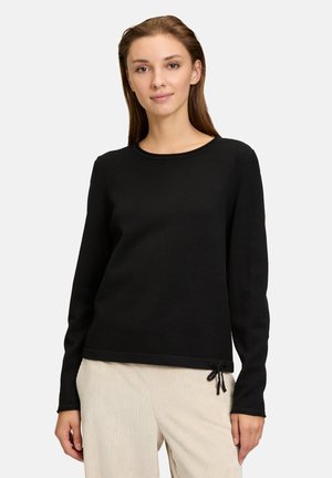 Schwarzer Pullover mit langen Ärmeln und rundem Halsausschnitt, ausgestattet mit einem Kordelzugakzent am Saum, aus einem glatten, weichen Stoff gefertigt.