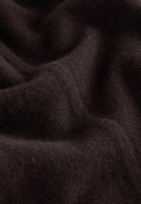 Soft, dark brown fabric with a smooth texture and slight sheen, featuring subtle variations and fine fibers. Curved folds create depth.