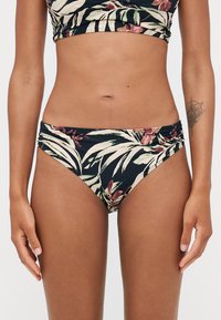 Bikini-bunn i svart med tropisk blomsterdesign. Laget av glatt stoff, med høye utskjæringer på sidene og en rynket midjebånd.