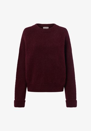 Bordo pulover napravljen od mekog, pahuljastog materijala. Okrugli izrez, rebrasti manžeti i rub. Labav kroj s minimalnim šavovima, što mu daje udoban izgled.
