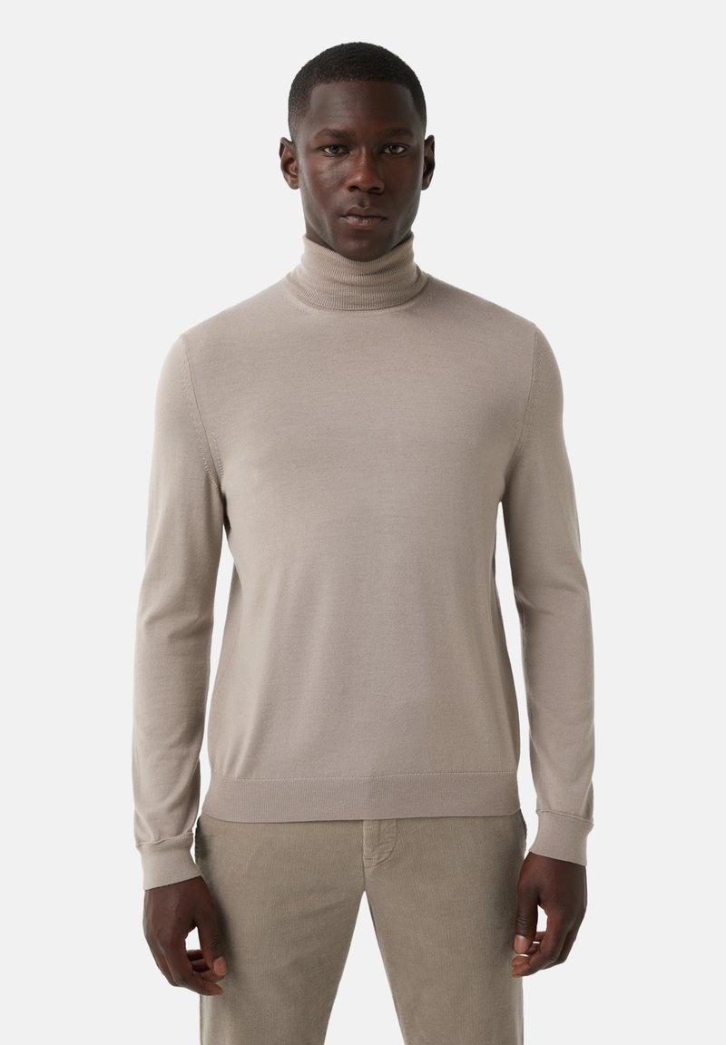 Pull à col roulé beige en tissu tricoté lisse. Il présente des manches longues, des poignets et un ourlet côtelés, avec une silhouette ajustée.