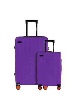 Purple hard-shell suitcases, one large and one small, featuring vertical grooves, black telescoping handles, and orange wheels.