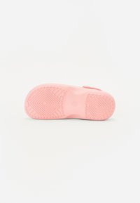 Light pink shoe sole with geometric tread pattern, smooth texture, and slight curvature at the heel. Designed for comfort and grip.