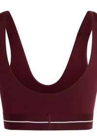Burgundy sports bra with wide straps, scoop neckline, and a contrasting white stripe along the bottom band. Smooth fabric texture.
