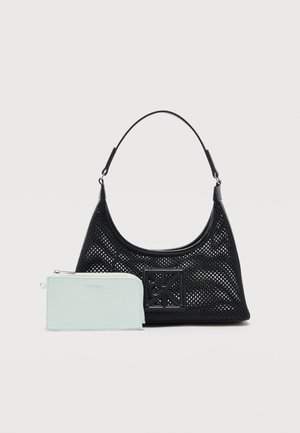 Black perforated shoulder bag with a square decorative emblem, accompanied by a light blue zippered wallet in front.