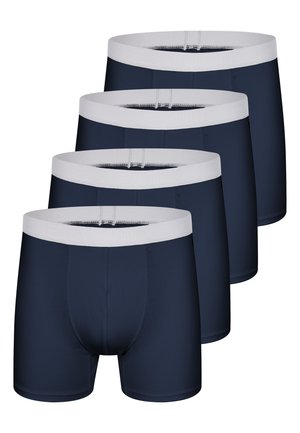 Fire par bukser i mørkeblå med hvide elastiske linninger, arrangeret i en forskudt stak på en hvid baggrund.