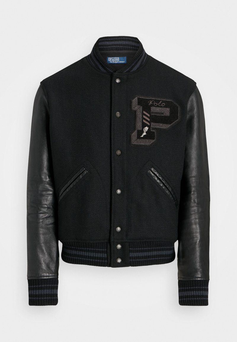 Black varsity jacket with wool body and leather sleeves. Features ribbed cuffs, a zippered front, and embroidered logo detail on the chest.