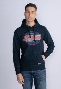 Marineblauwe hoodie van katoenmix, met een grote grafische print aan de voorkant, trekkoorden en een kangoeroezak. Klassieke pasvorm met ribgebreide boorden.