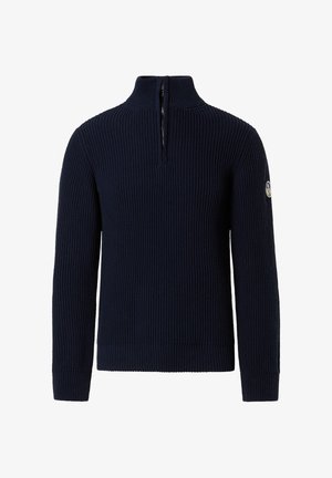 Pull bleu marine en tissu côtelé, avec un col haut zippé et un patch logo sur la manche gauche.