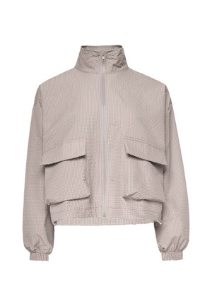 Giacca a quadri beige chiaro con collo alto, zip frontale, due grandi tasche con pattina, maniche lunghe e polsini elasticizzati.