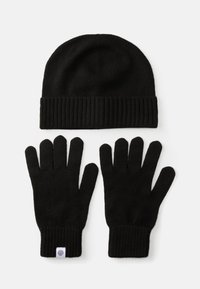 Gorro de malha preto com punho canelado e luvas de malha preta com pulso canelado também. Ambos os itens têm textura e apresentam um design sem emendas.
