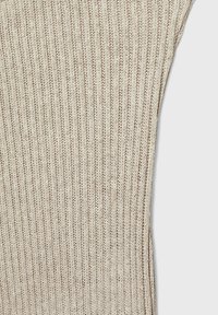Tissu en tricot côtelé beige présentant des lignes verticales et une texture douce. Le matériau a une qualité légère et respirante avec un léger éclat.