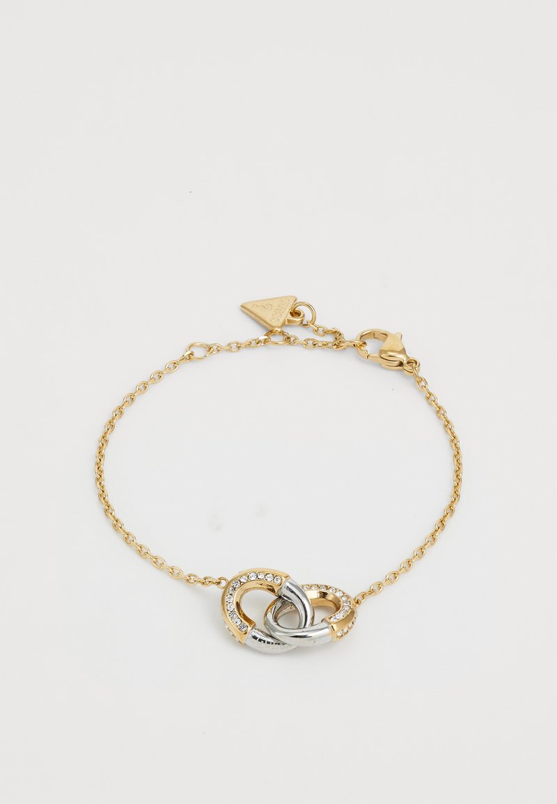 Gold chain bracelet featuring a twisted silver and gold accent, embellished with clear rhinestones at the center. Secure lobster clasp closure.