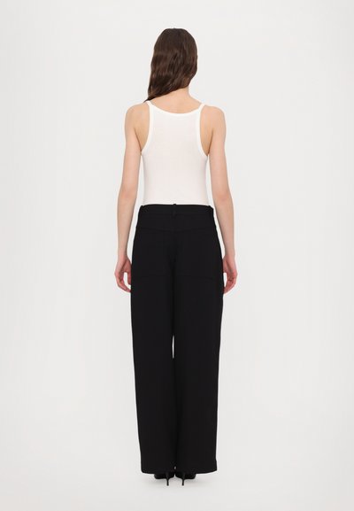 Black wide-leg trousers with a high waist, featuring two back pockets and a discreet button closure. The material appears smooth and textured.