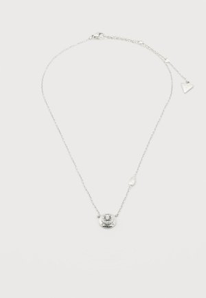 Delicate silver chain necklace with a circular pendant featuring a central clear gemstone and a small triangular charm near the clasp.