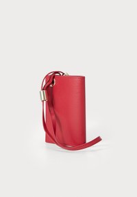 Red textured leather wallet with a cylindrical shape, featuring a braided strap and gold-tone hardware detail for secure carrying.