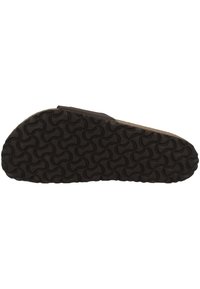 Suola di scarpa in gomma nera con un motivo ondulato e testurizzato per aderenza e stabilità. Include un design piatto per una facile calzata.
