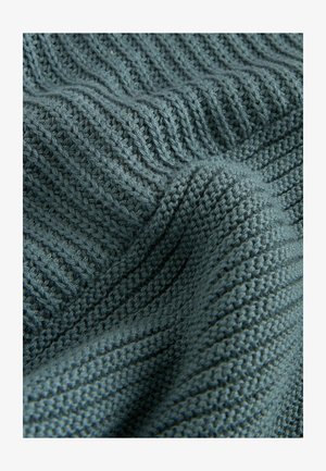 Tessuto a maglia testurizzato in un colore teal smorzato, caratterizzato da un motivo a coste con punti in rilievo e un aspetto morbido e accogliente.