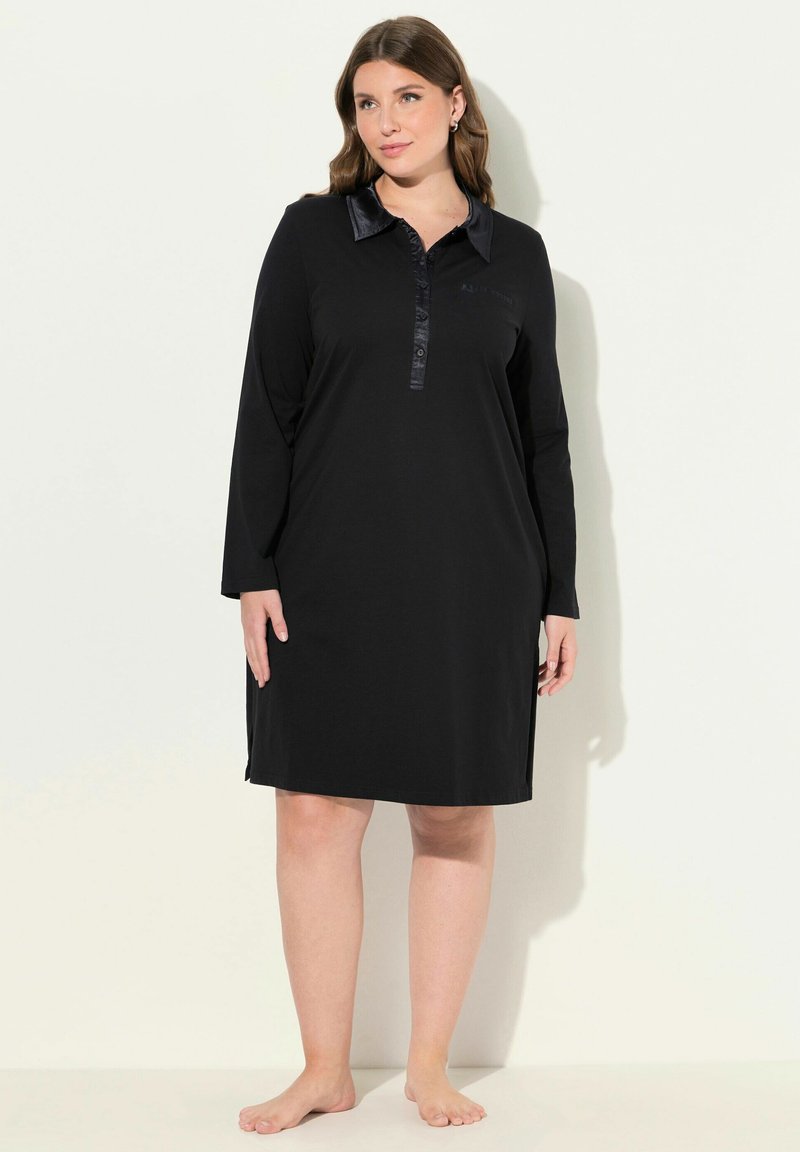 Vestido negro de manga larga con tapa de botones, cuello de satén y aberturas laterales, hecho de una tela suave. Diseño sencillo, corte a la altura de la rodilla.