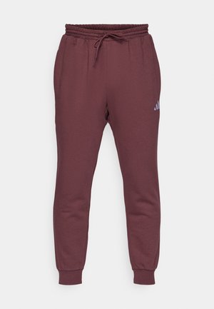Burgundy jogger pants made of soft fabric, featuring an elastic waistband with drawstring, ribbed cuffs, and a small light-colored logo.