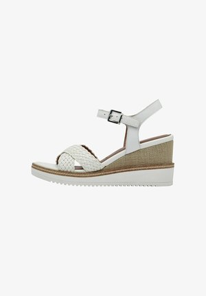 White leather wedge sandals with woven cross straps, adjustable ankle strap, and textured beige wedge detail. Sleek and modern design.