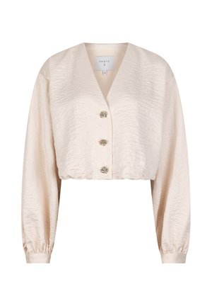 Kruisjack in beige met een gestructureerde satijnen afwerking, voorzien van een v-hals, lange mouwen en drie decoratieve knoopsluitingen aan de voorkant.