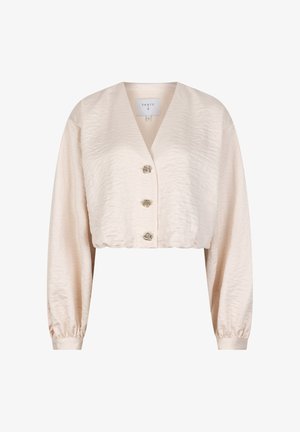 Kruisjack in beige met een gestructureerde satijnen afwerking, voorzien van een v-hals, lange mouwen en drie decoratieve knoopsluitingen aan de voorkant.
