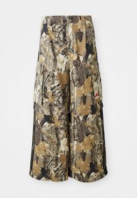 Καμουφλάζ cargo παντελόνι σε καφέ και μπεζ, με μοτίβα φύλλων, ελαστική μέση, πλαϊνές τσέπες και μαύρες λωρίδες στο πλάι. Ελαφρύ ύφασμα.