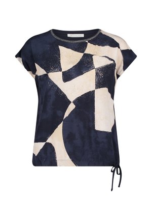 Kurzarmbluse mit abstraktem schwarz-beige geometrischem Muster und einer seitlichen Schleifendetail am Saum.