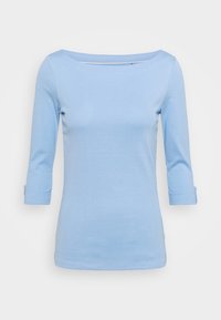 Light blue, long-sleeve top with a wide neckline. Made of soft fabric. Features rolled cuffs and a fitted shape. Simple design with no patterns.