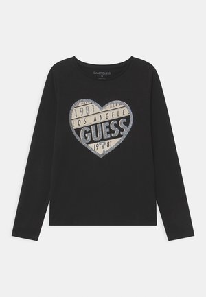 Sort langærmet skjorte med et glitrende hjerteformet logo med teksten "LOS ANGELES", "GUESS" og "1981" foran.