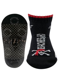 Schwarze Socken mit einem Design von Totenkopf und gekreuzten Knochen, roten Akzenten und einer strukturierten, rutschfesten schwarzen Sohle mit kreisförmigen Griffmustern.